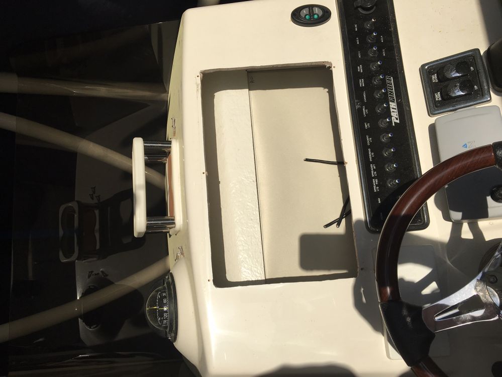 The hole left by the thieves that stole the 16" Garmin chart plotter/fishfinder and ruined all other networked electronics. Over $10,000 loss.